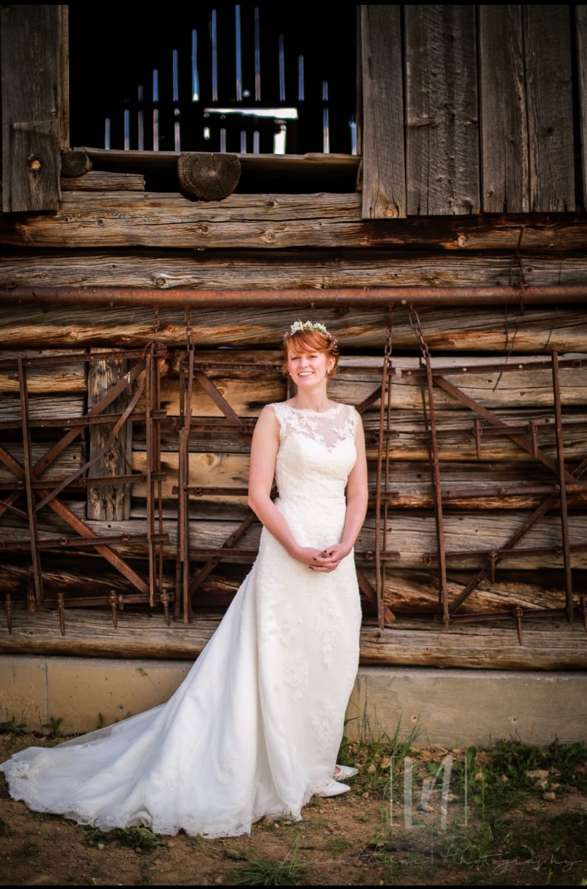 Bride portrait in front of the rustic log barn