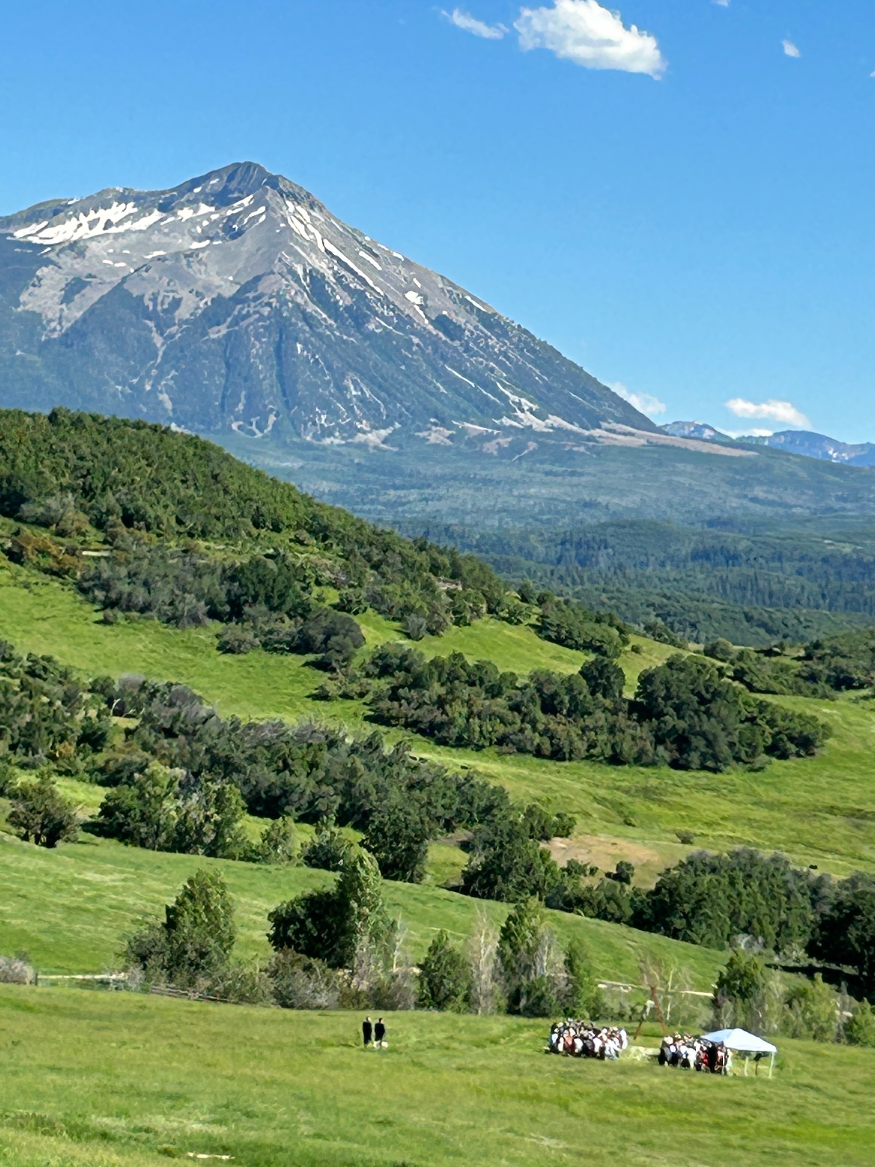 Sweeping valley view of the ceremony site with Ragged Mountain and lush forested hillsides stretching to the horizon