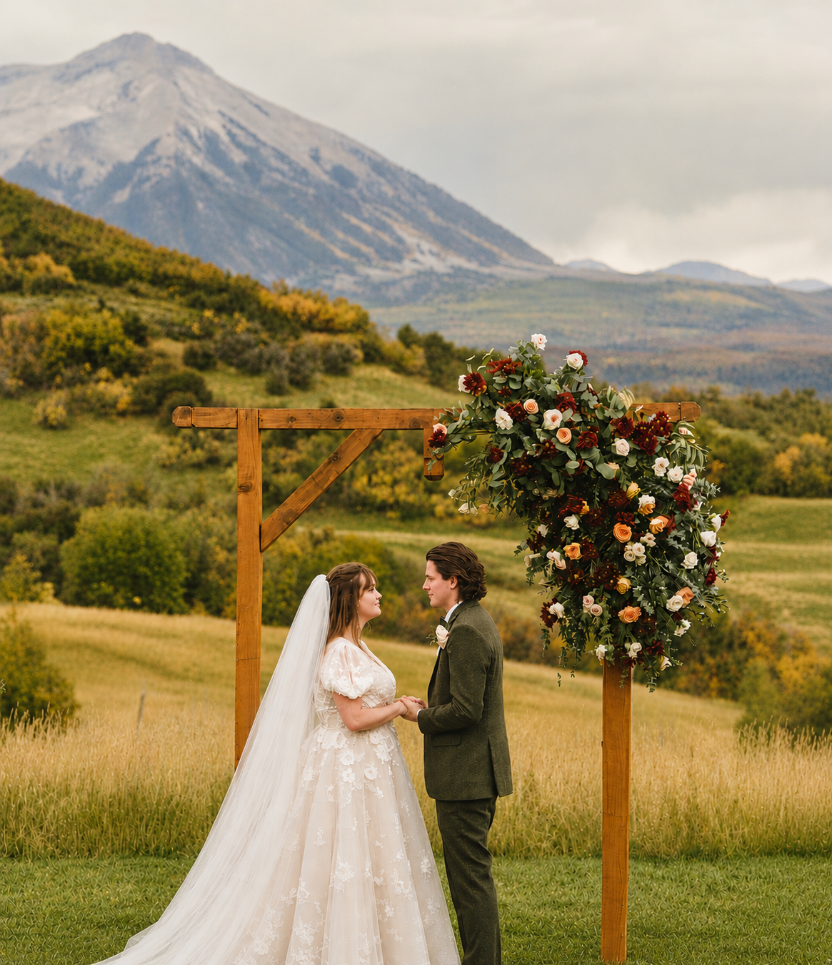 Bride and groom with horse-drawn carriage in mountain valley