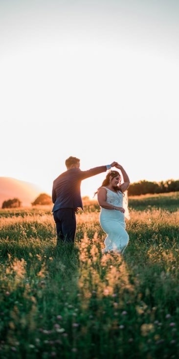 Couple celebrating in mountain valley
